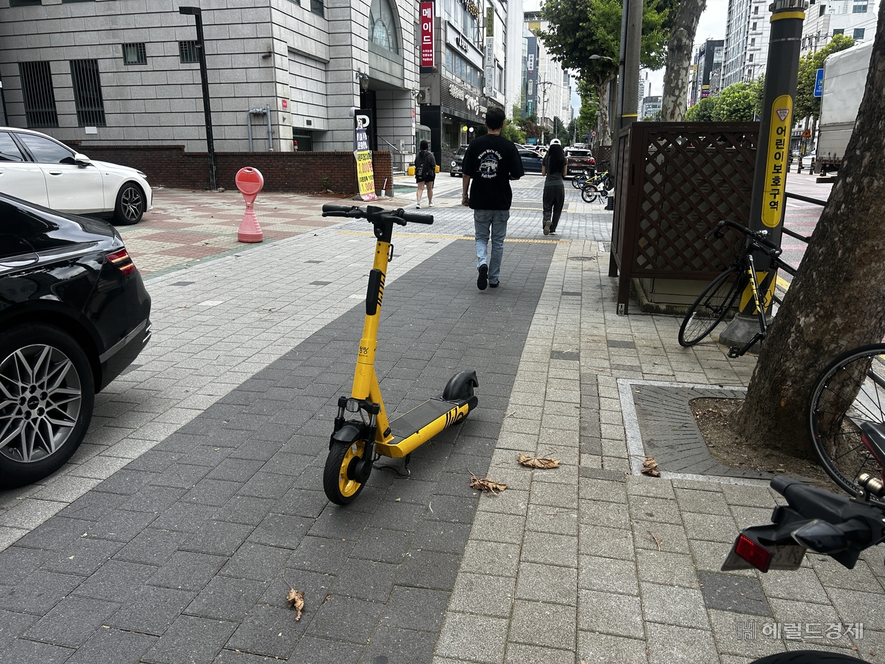 An e-scooter left in the middle of a pedestrian walkway in the hagwon district of Daechi-dong, Gangnam-gu, Seoul, on Monday morning. [Lee Jun-young/The Herald Business]