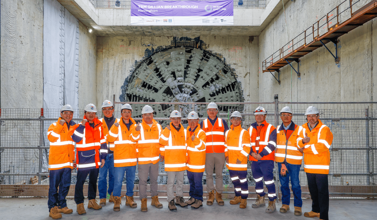 GS E&C employees and key officials pose for a photo after completing TBM tunneling at the Australia North East Link highway tunnel construction site. (GS E&C)