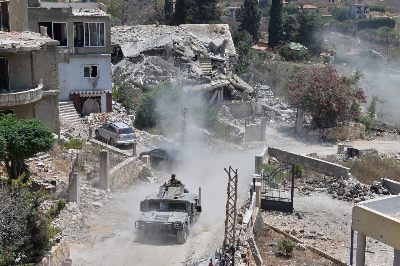 A Lebanese military vehicle drives past homes damaged during the war in the southern village of Zawtar al-Gharbieh, Lebanon, Monday. (AP-Yonhap)
