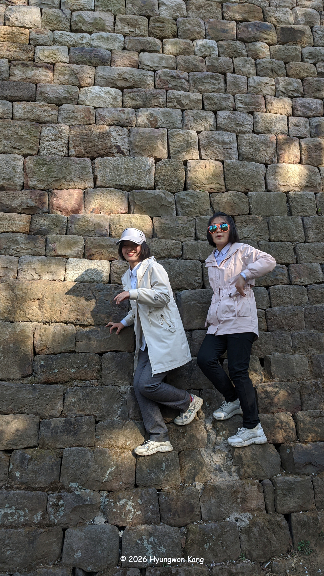 Schoolgirls climb the stone fortress walls beneath Ulmil Pavilion, a sixth-century structure designated as National Treasure No. 19, at the northern end of the 16-kilometer-long Pyongyang Fortress, which encloses central Pyongyang between two rivers. (Hyungwon Kang)