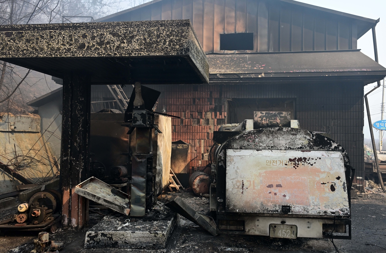 This March 26, 2025, photo shows a gas station in Yeongdeok-gun County, North Gyeongsang Province, that was destroyed in the massive wildfire last year. (Lee Sang-seob/The Korea Herald)