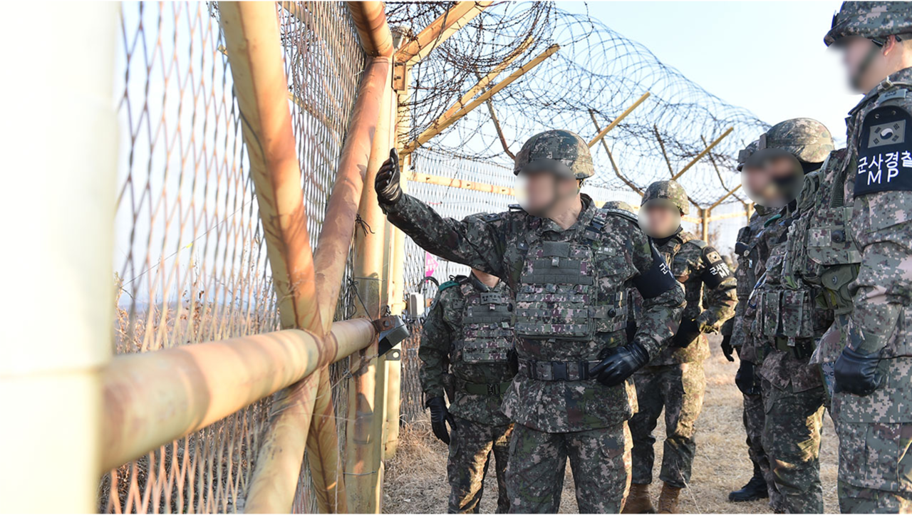 South Korean military personnel inspect the fence at a military installation. (Joint Chiefs of Staff)