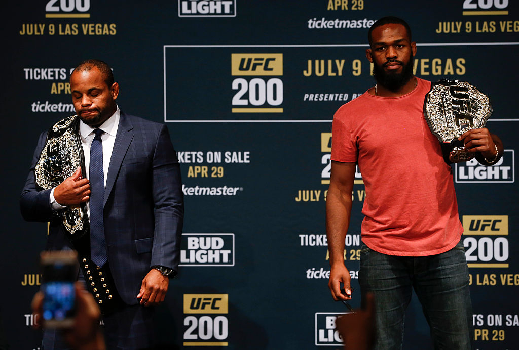 Daniel Cormier (left) and Jon Jones hold their title belts at a UFC 200 press event in New York in 2016. The fight was later canceled after Jones tested positive for a banned substance. [Getty Images]