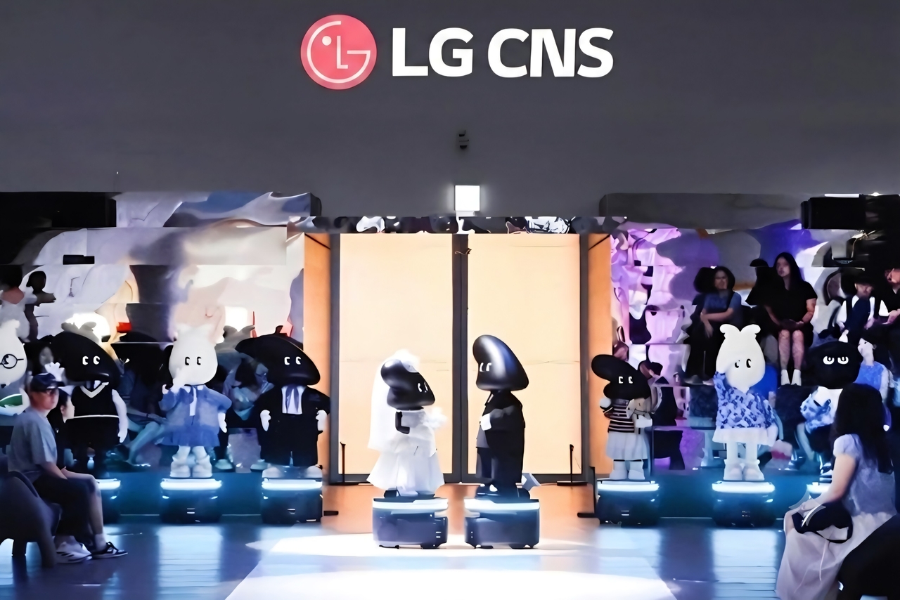 LG CNS 전시장을 찾은 관람객들이 AGV로봇의 런웨이 퍼포먼스를 관람하고 있다.[LG CNS 제공]