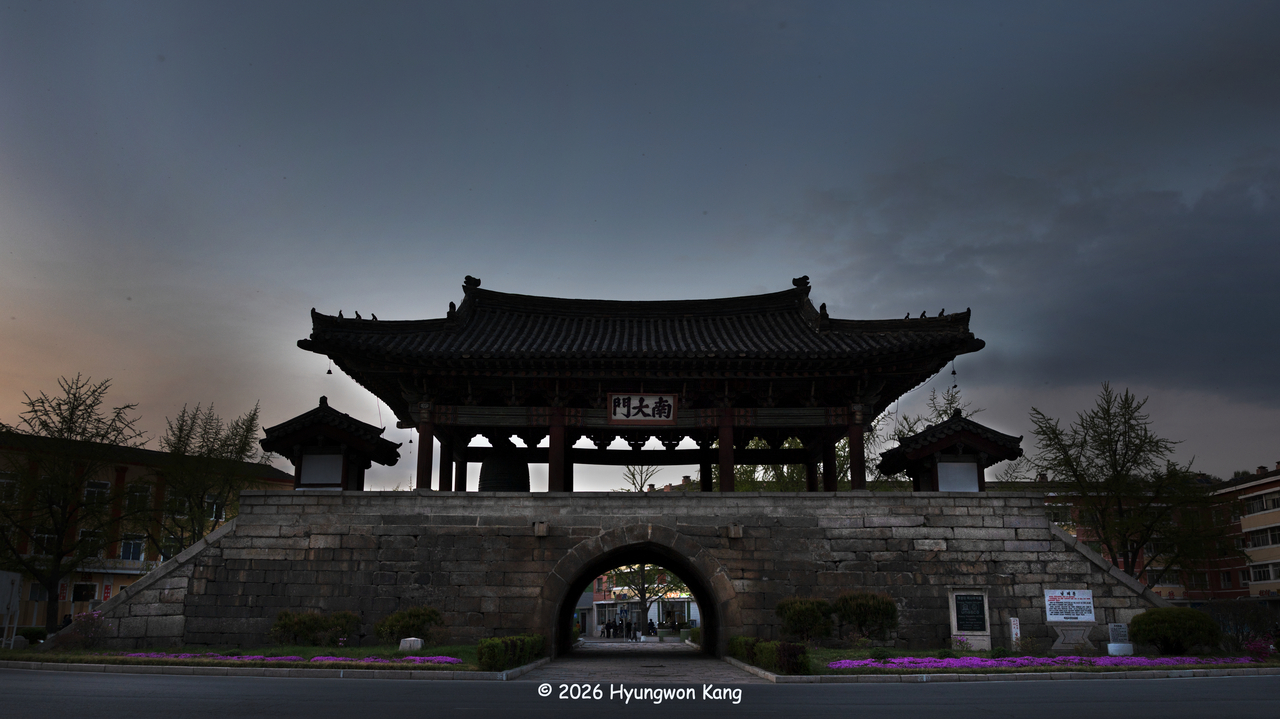 Kaesong Namdaemun, North Korean National Treasure No. 124, is the only surviving gate of the fortified imperial capital that once led toward Manwoldae, the imperial palace of the Goryeo empire in Hwangdo (the imperial capital), present-day Kaesong, North Korea. Archaeologists have determined that the surrounding ground level has risen by approximately 3 meters since the gate was built, making it appear noticeably shorter today than it originally did. The gate has been part of the UNESCO World Heritage-listed Historic Monuments and Sites in Kaesong since 2013. (Hyungwon Kang)