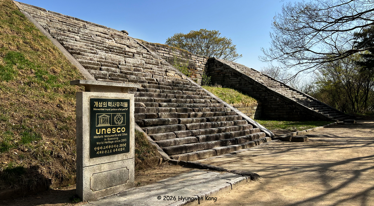 Monumental granite staircases ascend the terraced remains of Manwoldae, the imperial palace of the Goryeo empire in Kaesong, North Korea. Four great staircases led to Hoegyeongjeon, the main audience hall, while archaeological evidence suggests that a fifth central staircase existed during certain periods. The site was inscribed as part of the UNESCO World Heritage-listed Historic Monuments and Sites in Kaesong in 2013. (Hyungwon Kang)