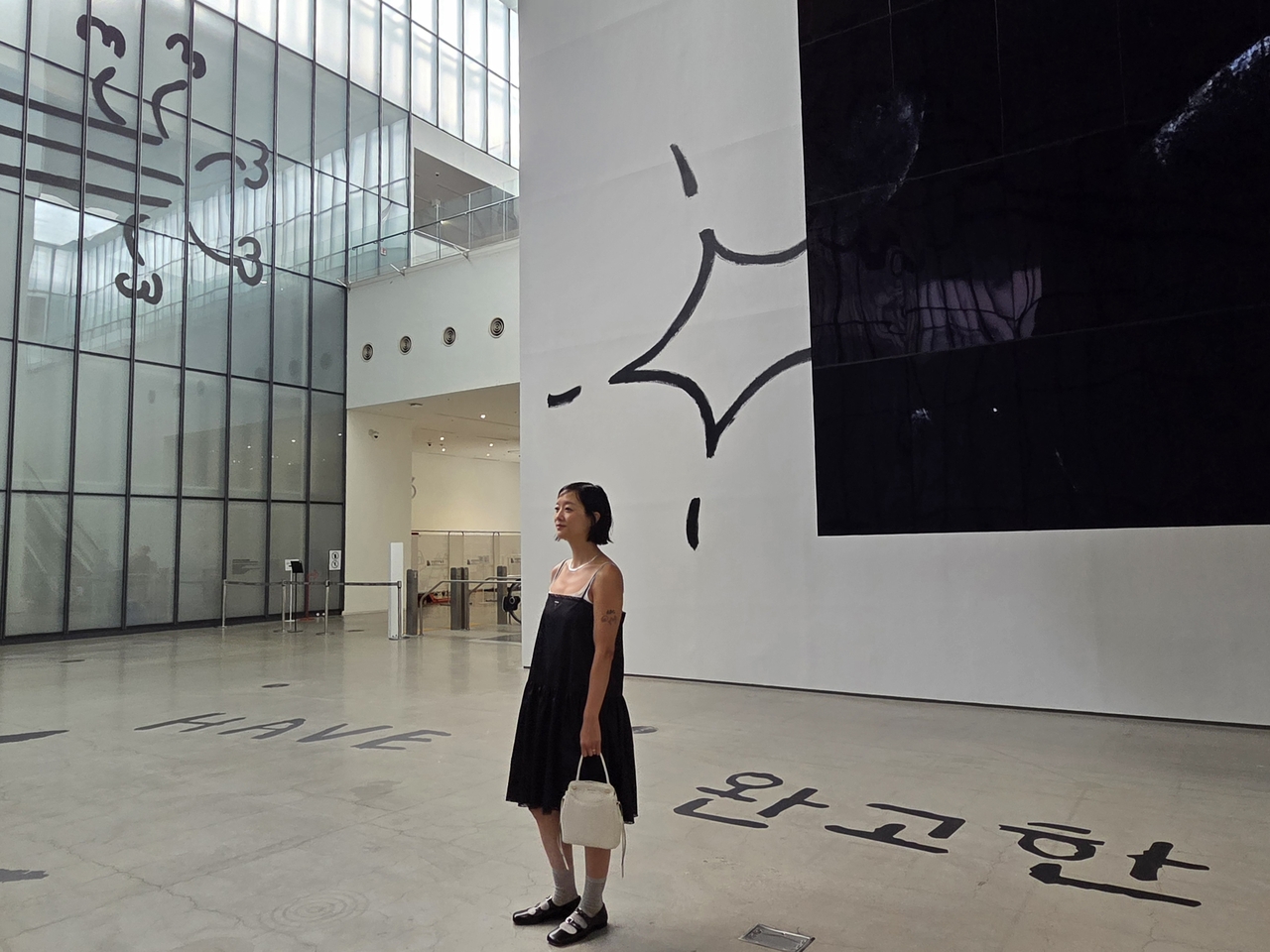 Christine Sun Kim poses for a photo on Thursday at the "MMCA × LG OLED Series 2026: Christine Sun Kim ― Have Many Dumb Fights Against Rock" exhibition at MMCA Seoul. (Park Yuna/The Korea Herald)