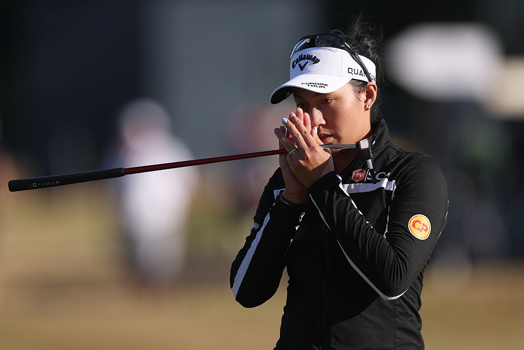 Jeeno Thitikul clasps her hands after making her par putt on the 18th hole, the final hole of Round 1 of the AIG Women's Open, on Thursday. [Getty Images]