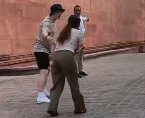 A screenshot from a circulating video shows a South Korean tourist bitten by a monkey at India's Taj Mahal. (Online communities)