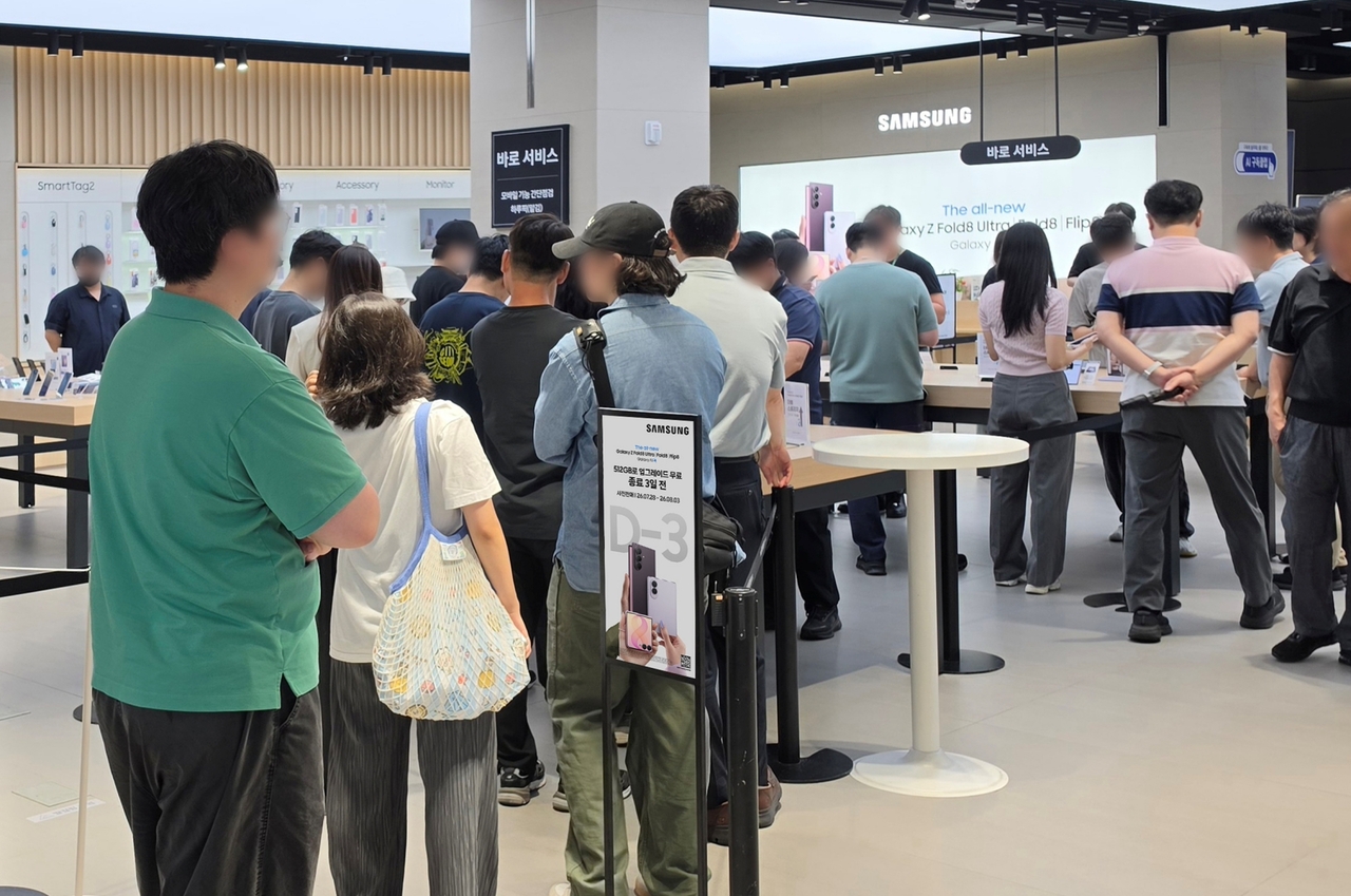 Visitors browse Samsung Electronics' Galaxy Z series at Samsung Store The Hyundai Seoul ahead of pre-orders. [Samsung Electronics]