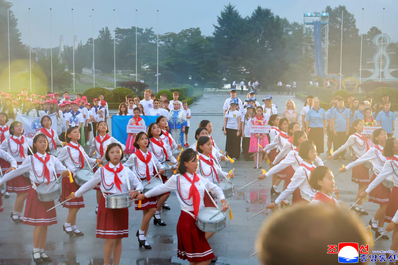 North Korean youths play drums during a ceremony at Songdowon in Wonsan on July 19. (KCNA via Yonhap)