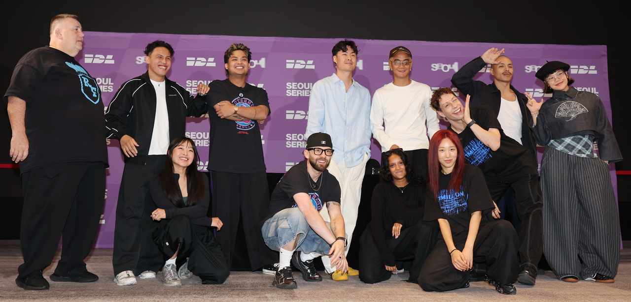 Connor Lim (center, back), co-founder and CEO of the International Dance League, poses with representatives from participating teams during a press conference in Seoul on Friday. (Yonhap)