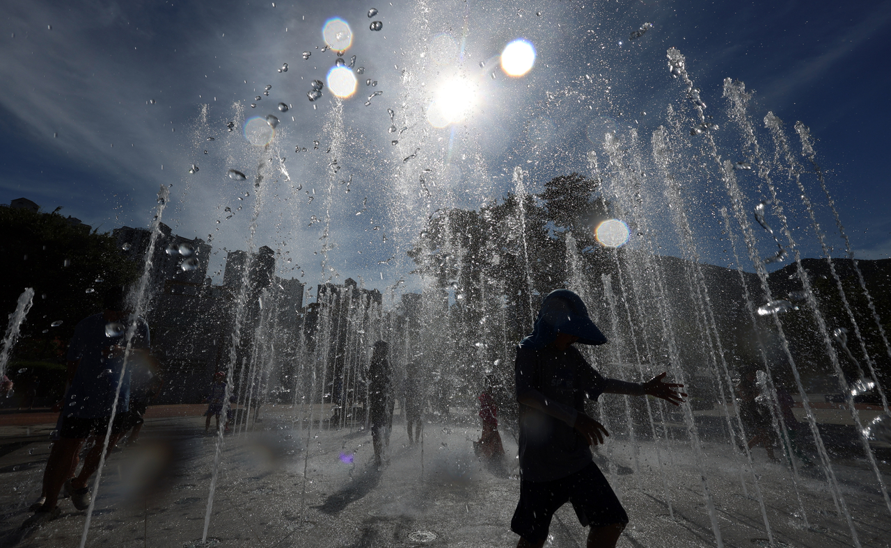 A person plays in the fountains at Yangsan Water Park in Yangsan, South Gyeongsang Province, on Friday, as temperatures in the area soared to 41.4 degrees Celsius amid a scorching heat wave. (Yonhap)