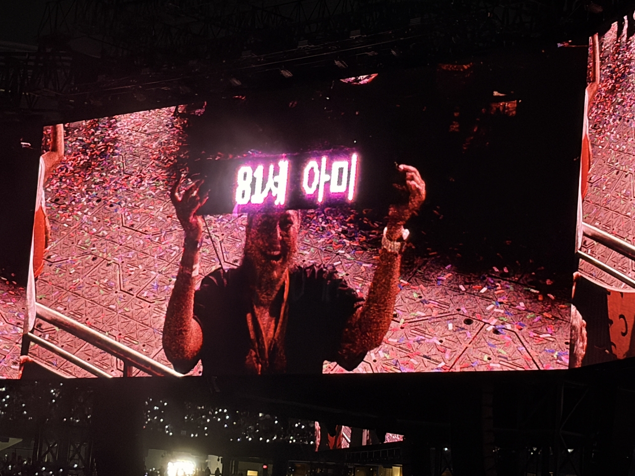 A fan holds a digital placard identifying herself as an 81-year-old Army during BTS' concert at MetLife Stadium in East Rutherford, New Jersey, Saturday. (Big Hit Music)