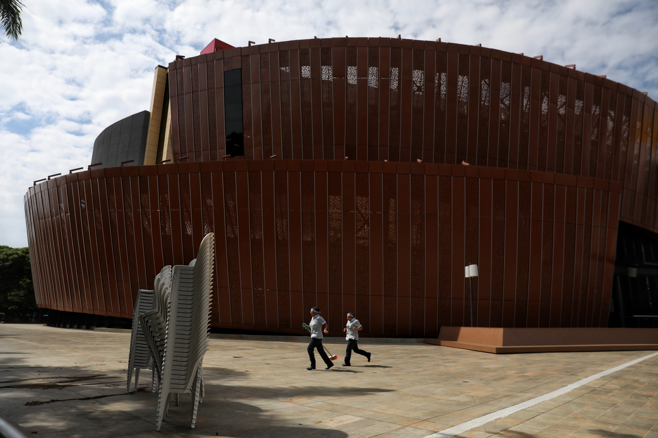 Janitors walk outside the Universidad Santiago de Cali auditorium, where President-elect Abelardo de la Espriella will be inaugurated, in Cali, Colombia. (AP)