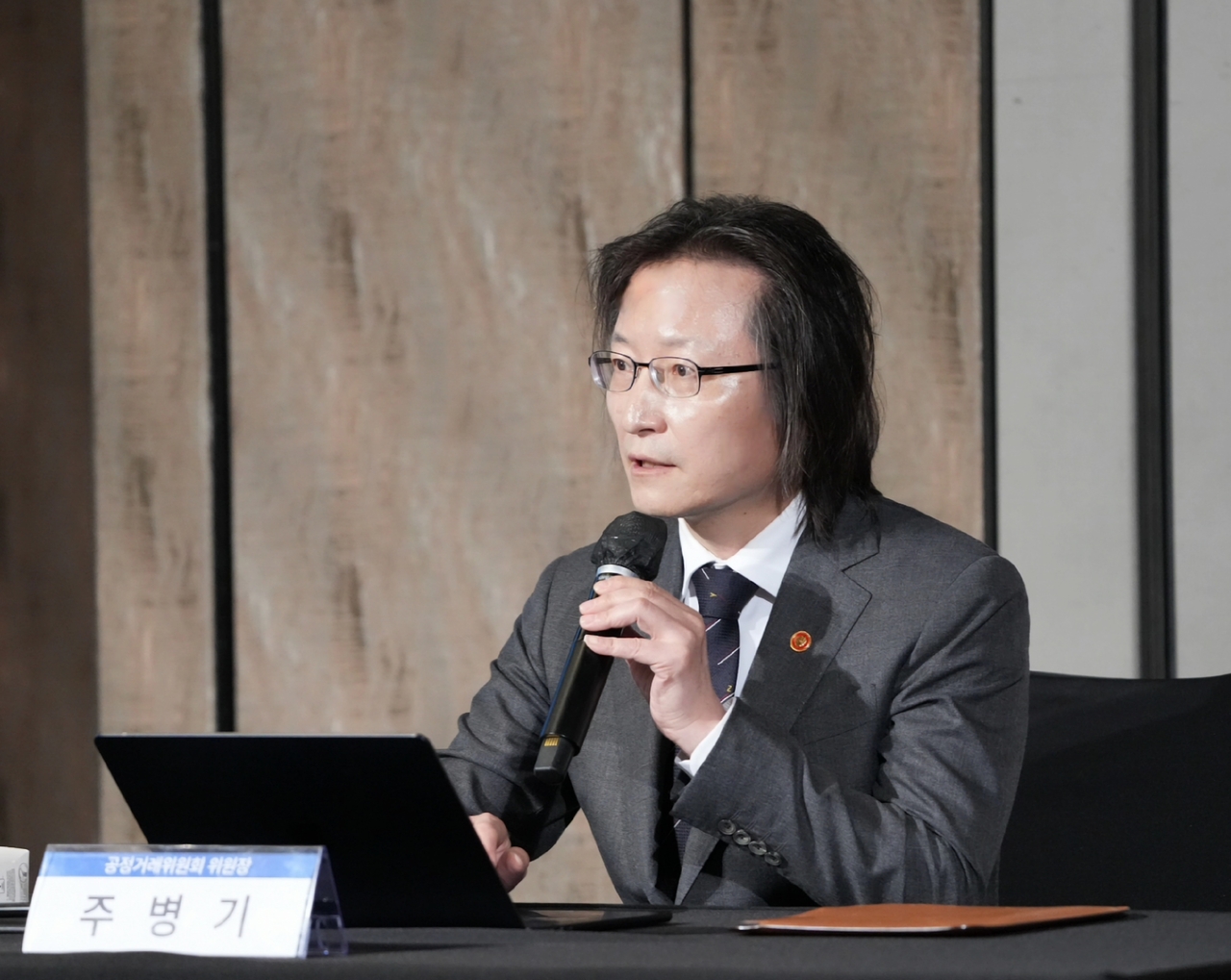This file photo provided by the Fair Trade Commission shows its chairman, Ju Biung-ghi, speaking during an event in Seoul on July 15, 2026. (Yonhap)