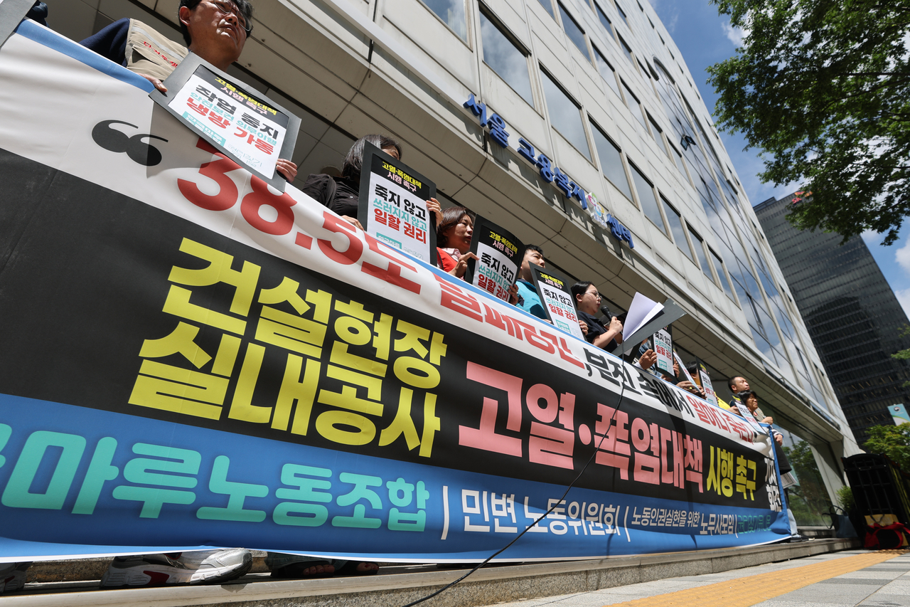 권리찾기유니온과 한국마루노동조합을 비롯한 단체 관계자들이 29일 서울 종로구 서울고용노동청 앞에서 건설현장 실내공사 고열·폭염대책 시행 촉구 기자회견을 열고 있다. 이들은 건설현장 실내공사 노동자들이 38도가 넘는 밀폐된 공간, 분진 속에서 일하면서도 폭염안전 5개 기본수칙(시원한 물 마시기, 냉방 장치, 2시간마다 20분 이상 휴식, 보냉장구 지급, 위급 시 119 신고 등) 준수 여건조차 보장받고 있지 못하고 있다며 대책을 촉구했다. [연합]