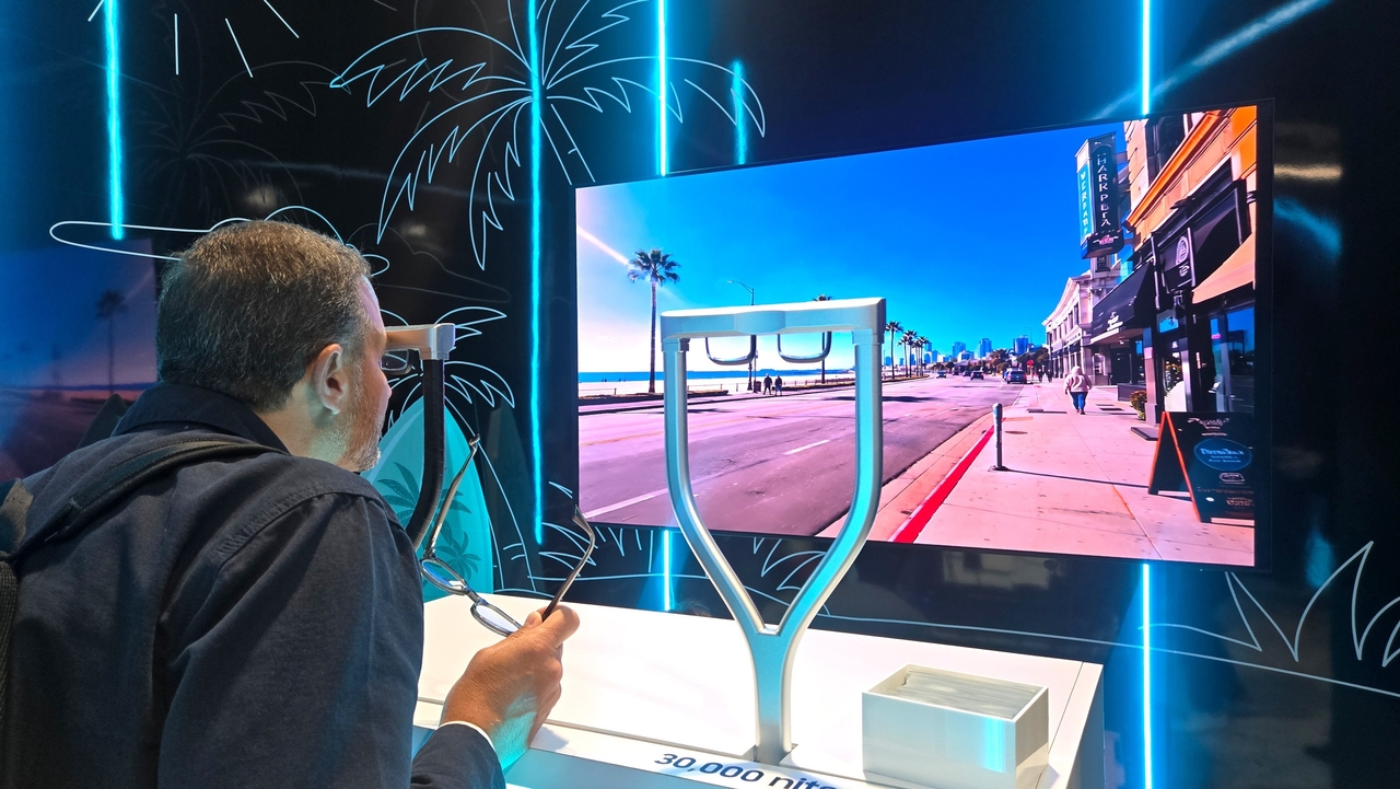 A visitor tries Samsung Display’s prototype AR glasses using a 0.62-inch RGB OLEDoS panel to show information such as navigation and translation at AWE USA 2026. (Samsung Display)
