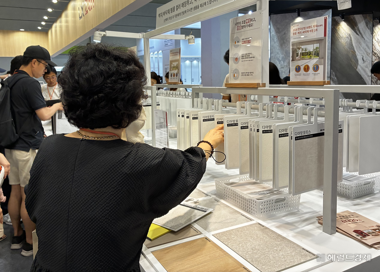 5일 코엑스에서 열린 ‘코리아빌드위크’에 샘플 벽지들이 옷걸이처럼 걸려 있다. 관람객들은 벽지 샘플을 골라 원하는 바닥재 샘플 위에 놓고 조합을 비교해 볼 수 있다. 김서현 기자