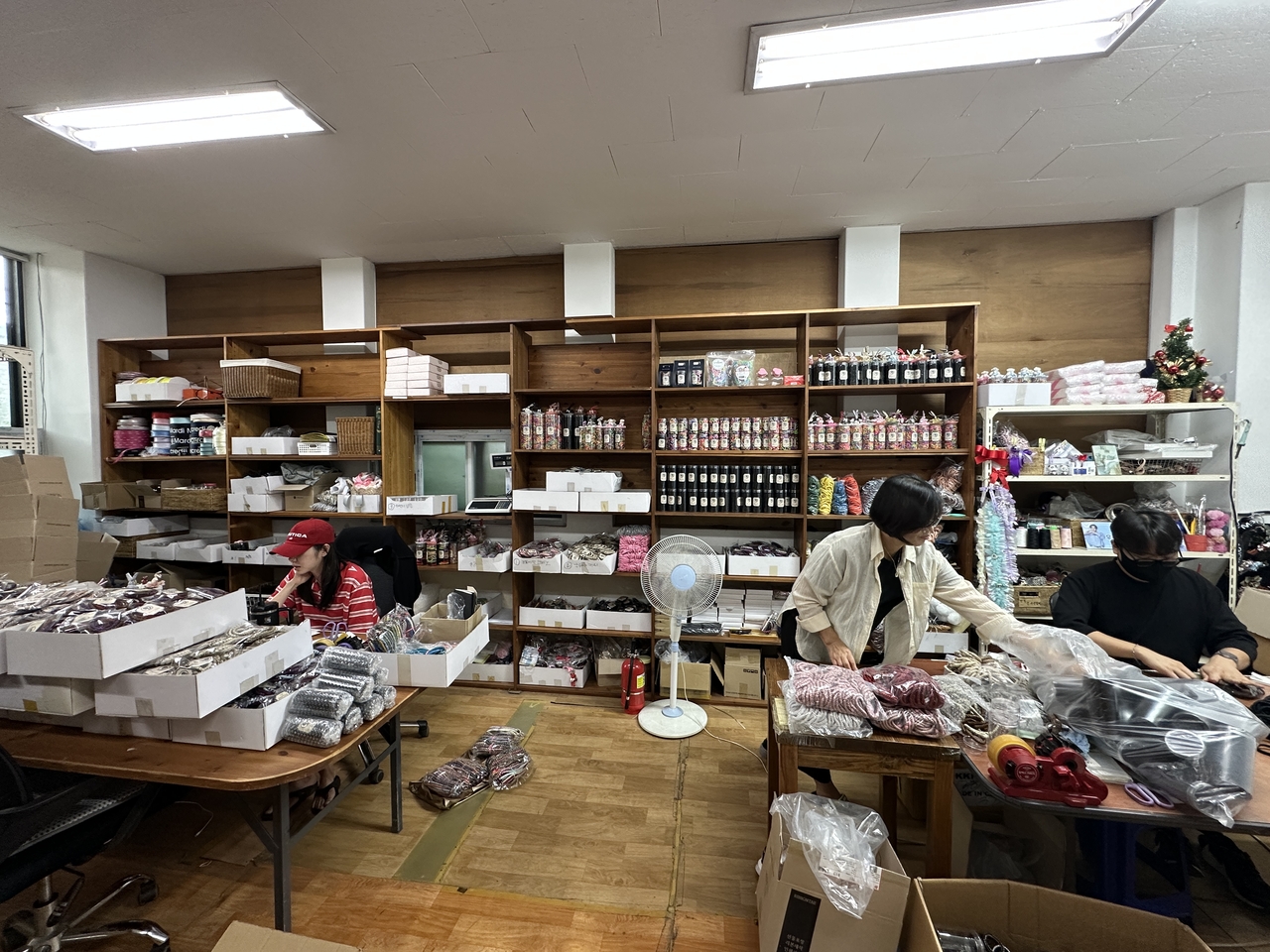 Staff sort various hair tie samples, including Kknekki, at Dooji's headquarters in Chuncheon, South Korea. (Tammy Park/The Korea Herald)