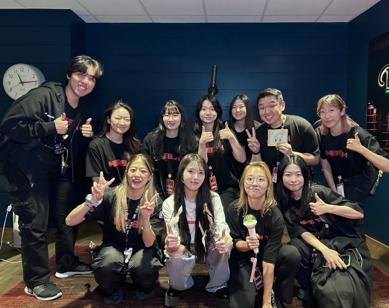 April Kim (front row, third from left) poses backstage with IU (front row, second from left) and members of the concert crew during the US leg of IU's 2024 world tour. (Courtesy of April Kim)