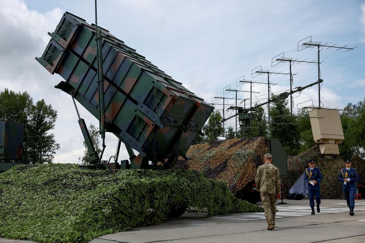 Ukrainian service members walk next to a launcher of a Patriot air defense system at an undisclosed location in Ukraine. (Reuters via Yonhap)