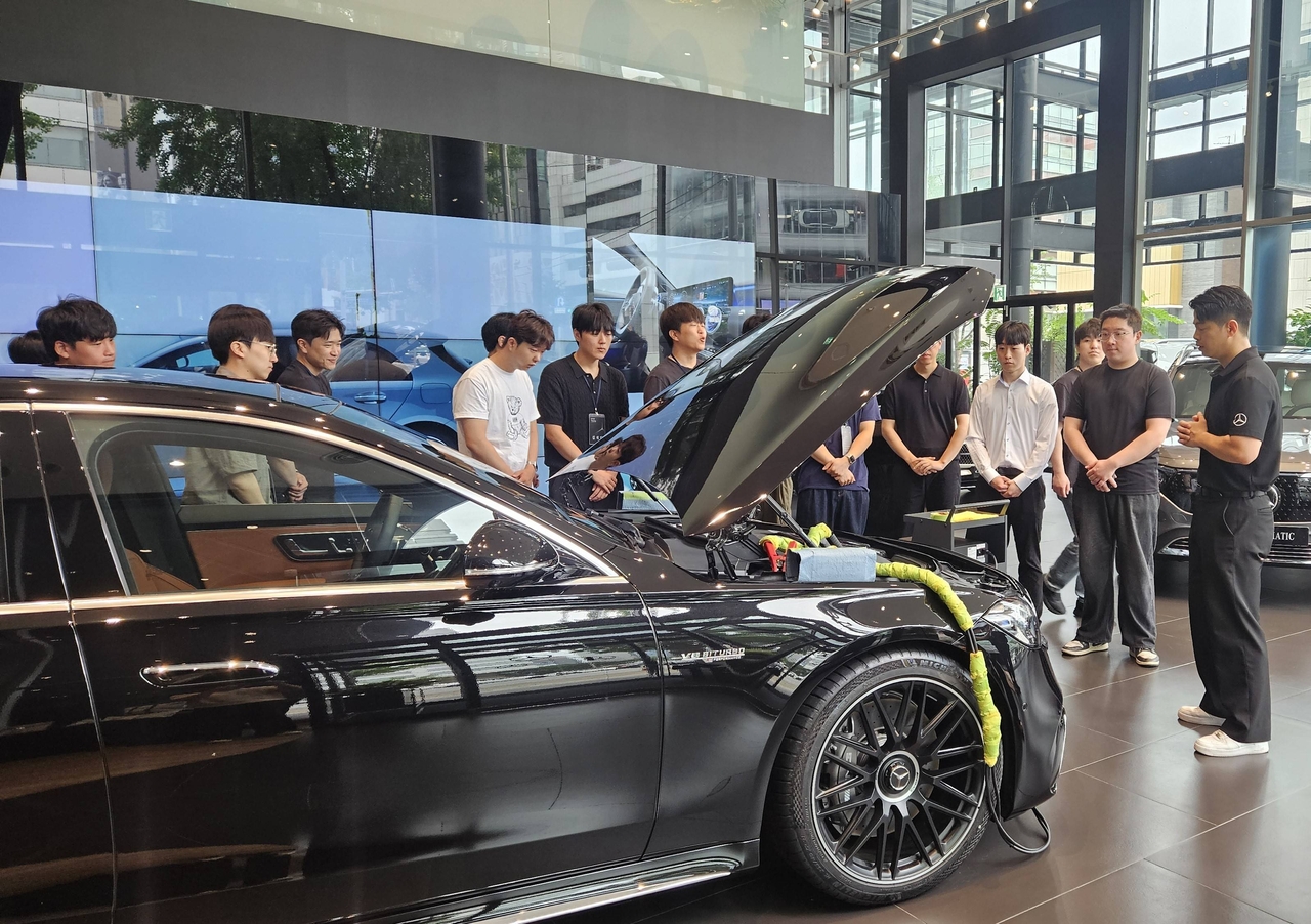 New technical staff at Hansung Motor receive training using a Mercedes-Benz display vehicle as part of the STAR Training program. [Hansung Motor]
