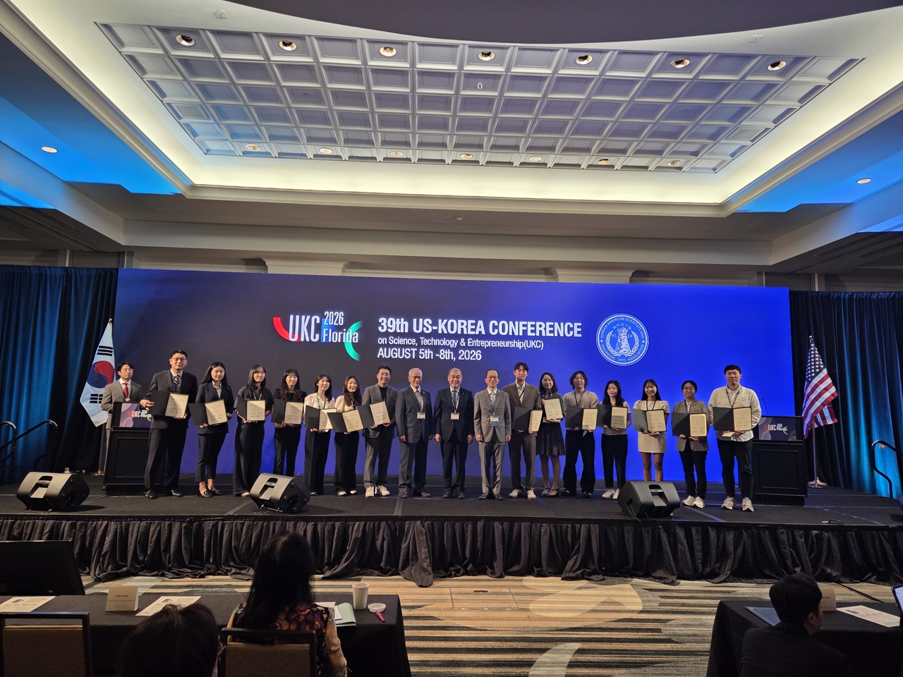 Hong Won-hwa, chairman of the National Research Foundation of Korea (ninth from right), poses for a group photo after presenting scholarships to 20 outstanding Korean and Korean-American graduate students in science and engineering in the United States at the 2026 US-Korea Conference on Science, Technology and Entrepreneurship, held at the Omni Orlando Resort in Orlando, Florida, on Thursday (local time). [National Research Foundation of Korea]