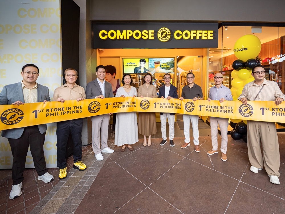 Officials from Compose Coffee and Fresh N' Famous Foods pose at the store's opening ceremony Friday in Manila, the Philippines. (Compose Coffee)