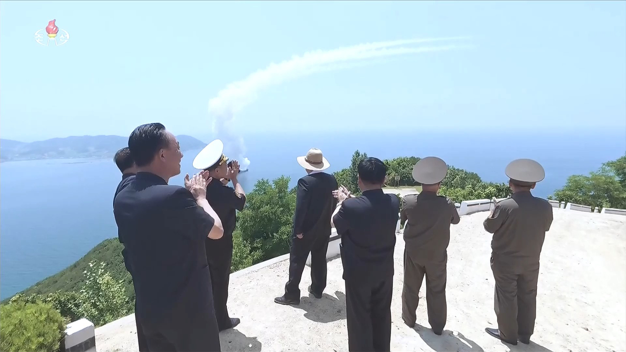 North Korean leader Kim Jong-un (center), alongside senior officials, observes tests of key weapons systems, including missiles and naval guns, aboard the new 5,000-ton-class destroyer Kang Kon on July 3. (Korean Central Television via Yonhap)