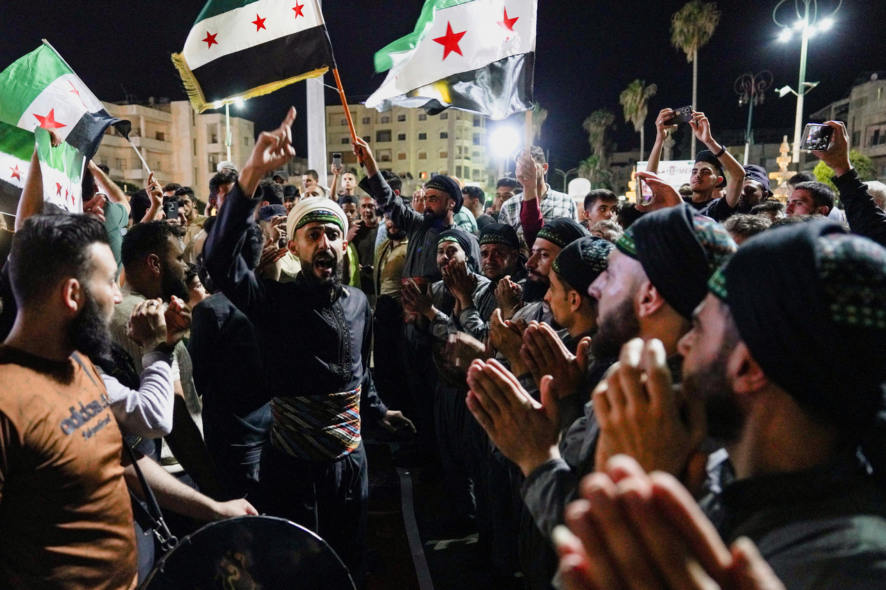 People with Syrian opposition flags gather during celebrations after a Syrian court sentenced ousted President Bashar Assad and officials who served under his rule to death, in Idlib, Syria, Tuesday. (Reuters-Yonhap)