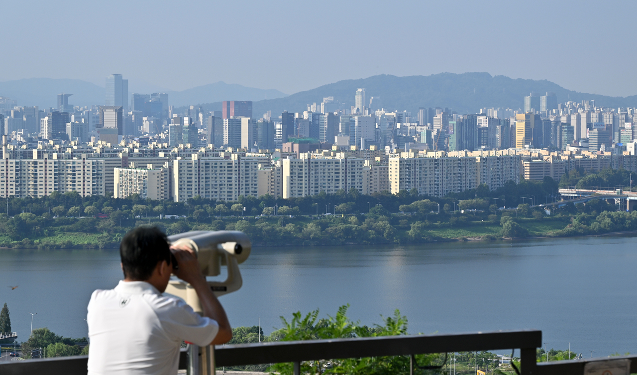 3일 오전 서울 성동구 응봉산 전망대에서 한 시민이 강남 아파트 단지를 살펴보고 있다. [헤럴드경제DB]