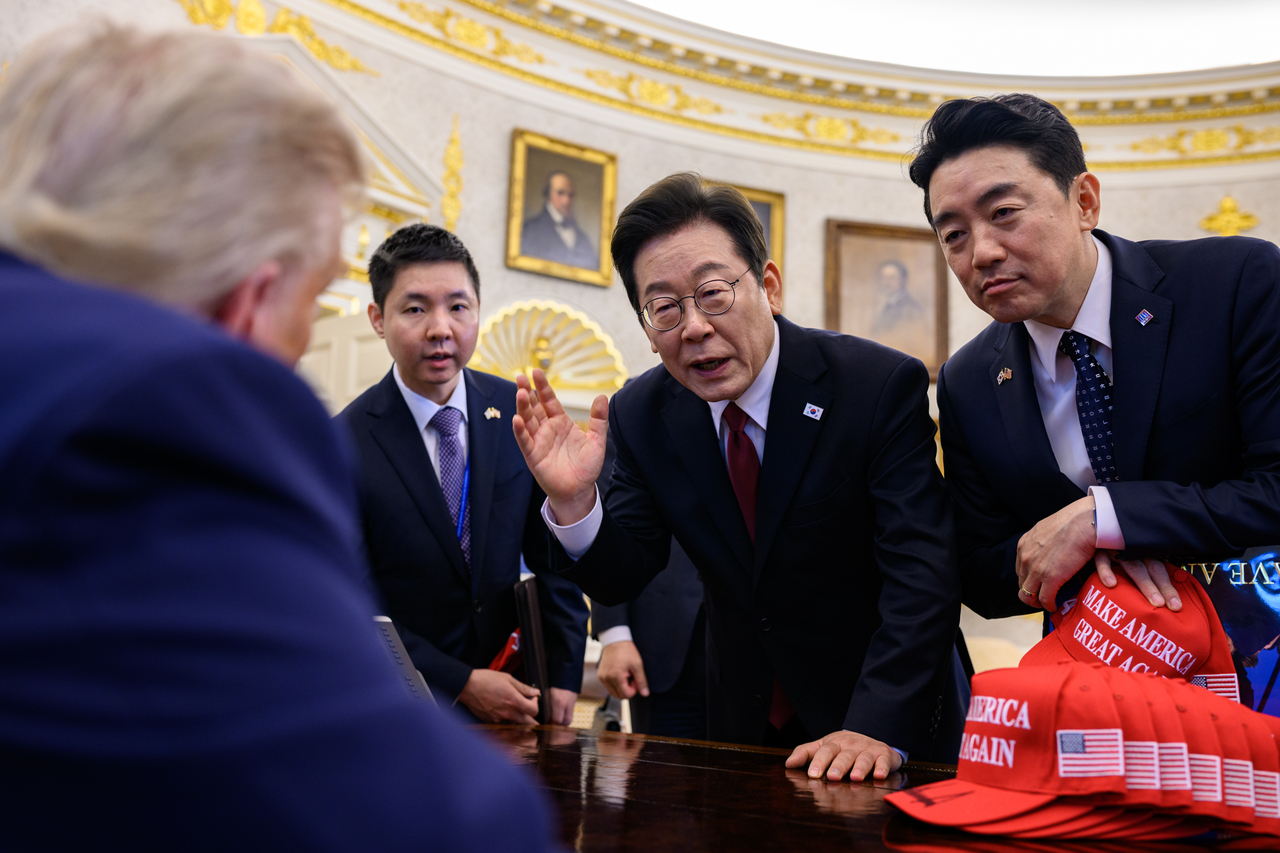 President Lee Jae Myung (second from right) gestures as he speaks with US President Donald Trump during their meeting in the Oval Office of the White House in Washington on Aug. 25, 2025. (White House)