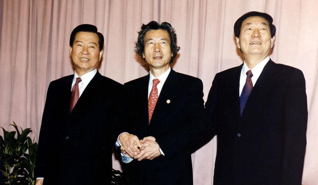 From left: President Kim Dae-jung, Japanese Prime Minister Junichiro Koizumi and Chinese Premier Zhu Rongji shake hands during a trilateral summit at the Centrepoint Hotel in Brunei on Nov. 5, 2001. (Presidential Archives)