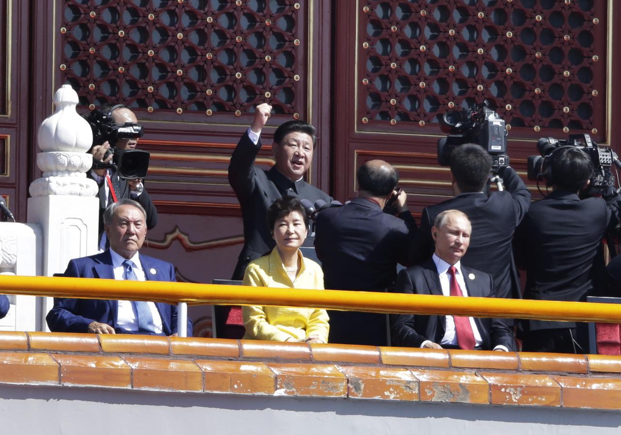 South Korean President Park Geun-hye (center) sits between Russian President Vladimir Putin (right) and Kazakhstan President Nursultan Nazarbayev on Tiananmen Gate as Chinese President Xi Jinping delivers remarks during a military parade in Beijing on Sept. 3, 2015, marking the 70th anniversary of the end of World War II. (Pool via Getty Images