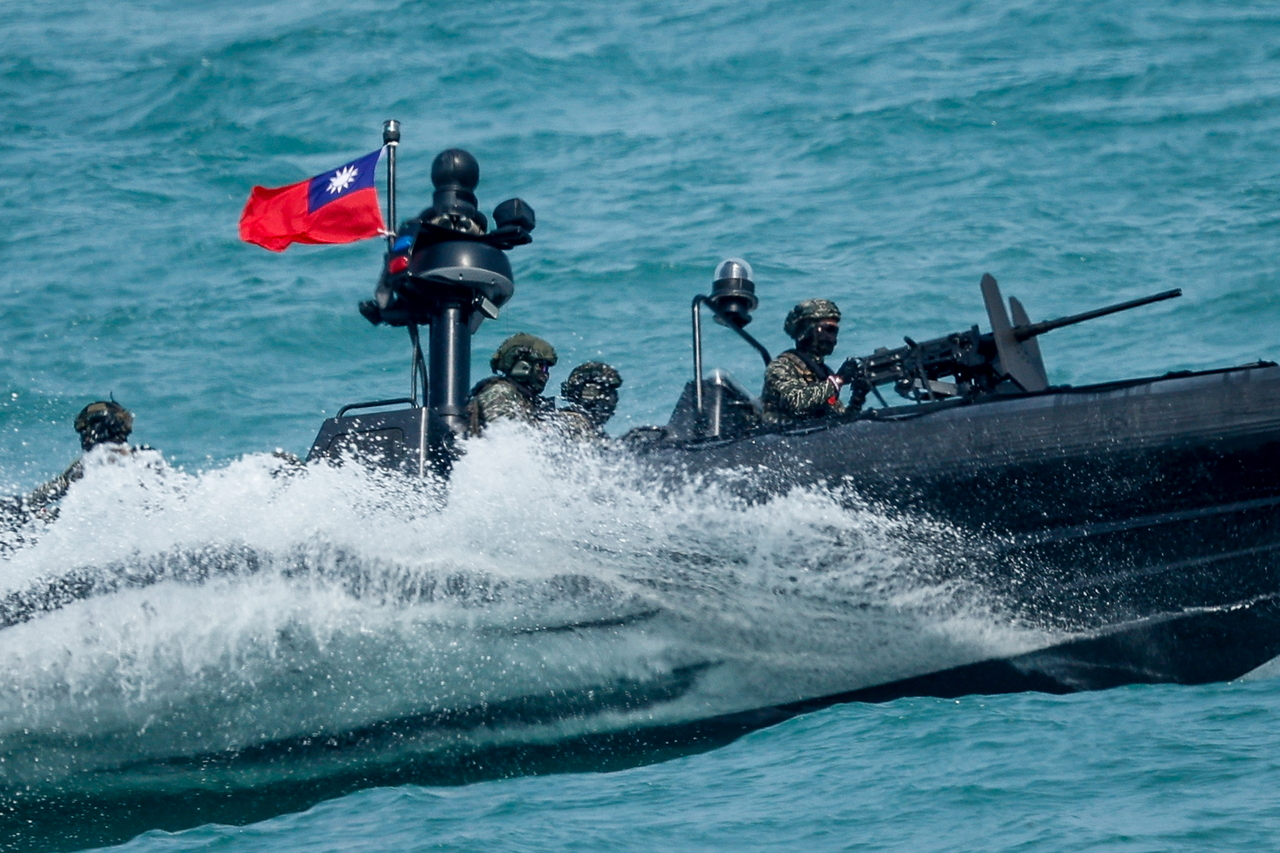 Taiwanese naval marines aboard a boat maneuver during a drill in Kaohsiung, Taiwan, Saturday. (EPA-Yonhap)