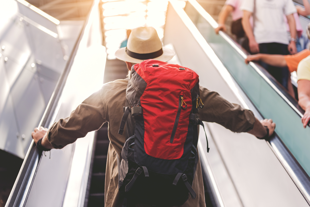 An elderly man on an escalator. (123rf)