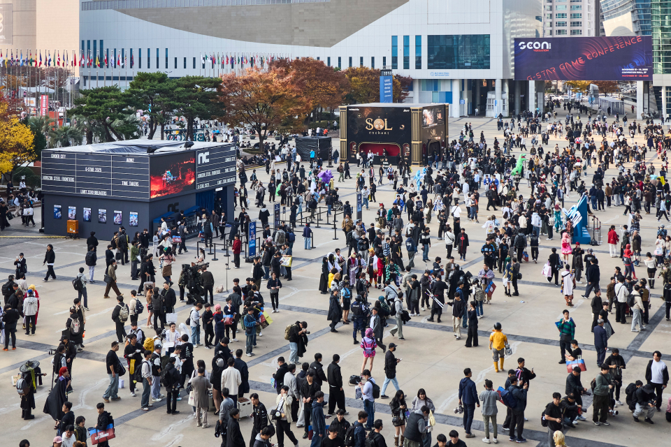 In this file photo, visitors to G-Star 2025 look around the outdoor exhibitions at Bexco in Busan in November 2025. (G-Star organizing committee)