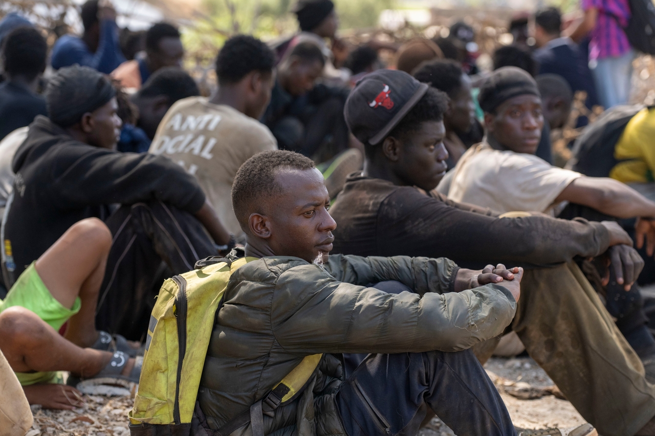 Migrants are detained by Moroccan security forces after attempting to cross to the Spanish enclave of Ceuta, Saturday. (AP-Yonhap)
