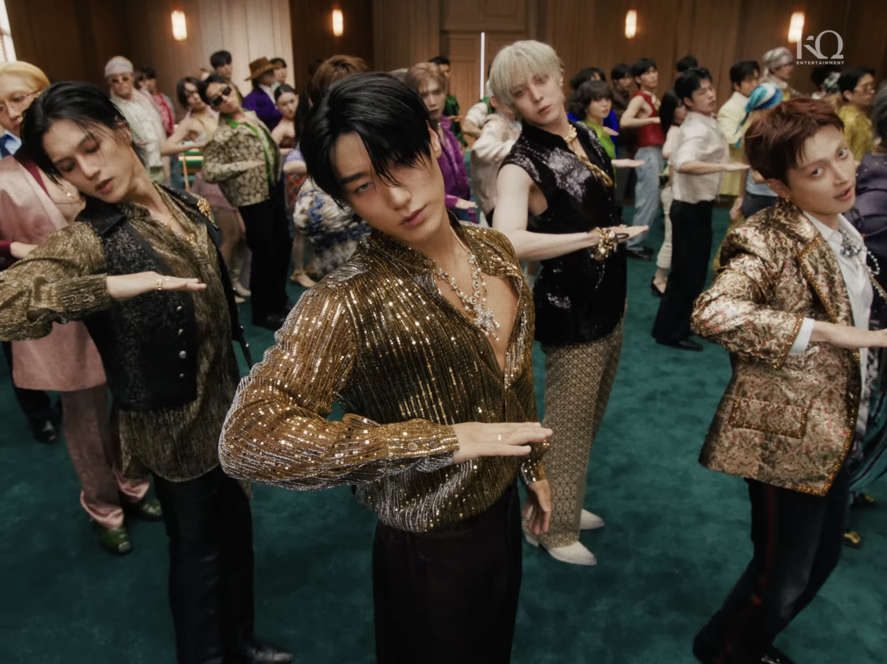 San (center) appears in the music video for "Bad." (KQ Entertainment)