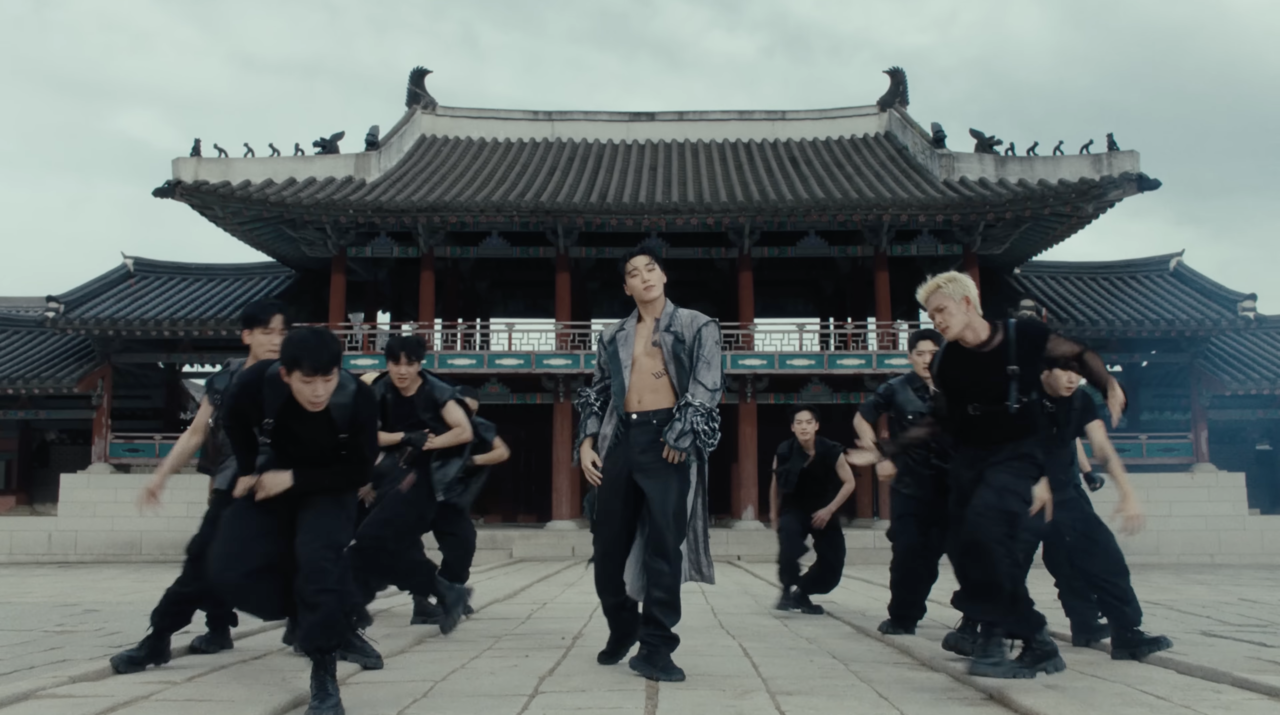San (center) performs Imagine Dragons' "Warriors" in a performance video released in October 2023. (KQ Entertainment)
