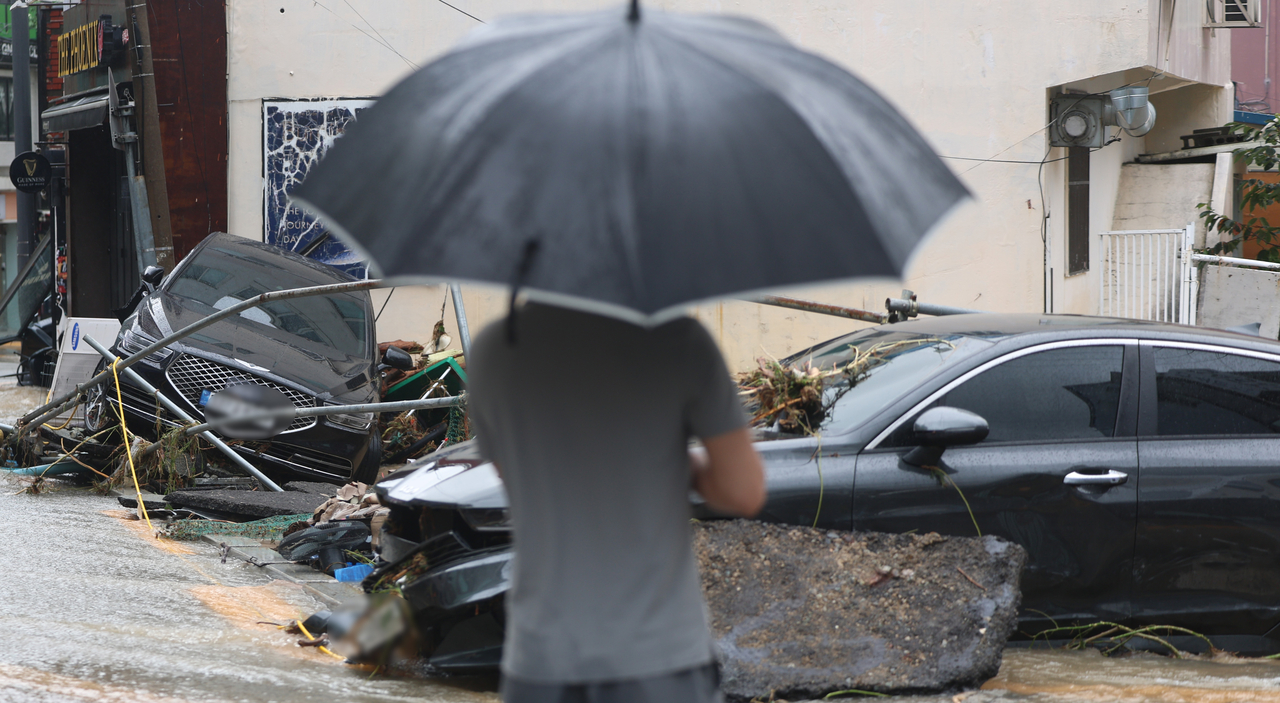 A passenger car is damaged in Okpo-dong, Geoje, South Gyeongsang Province, on Monday, after record-breaking rain fell over the Liberation Day holiday. (Yonhap)