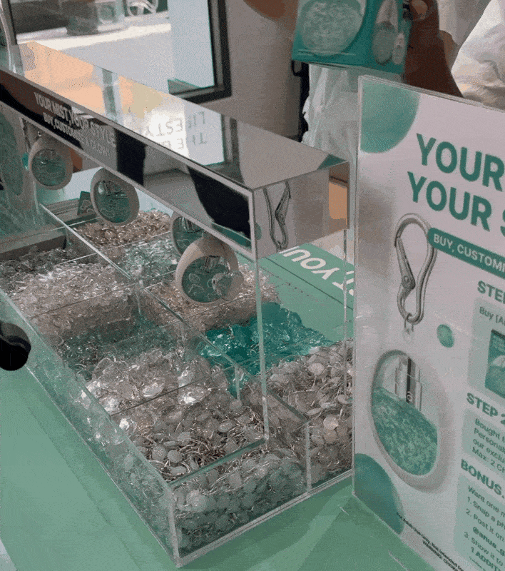Staffers show customers how to make key chains with Anua products at Olive Young's US store in Pasadena, California, Friday. (No Kyung-min/The Korea Herald)