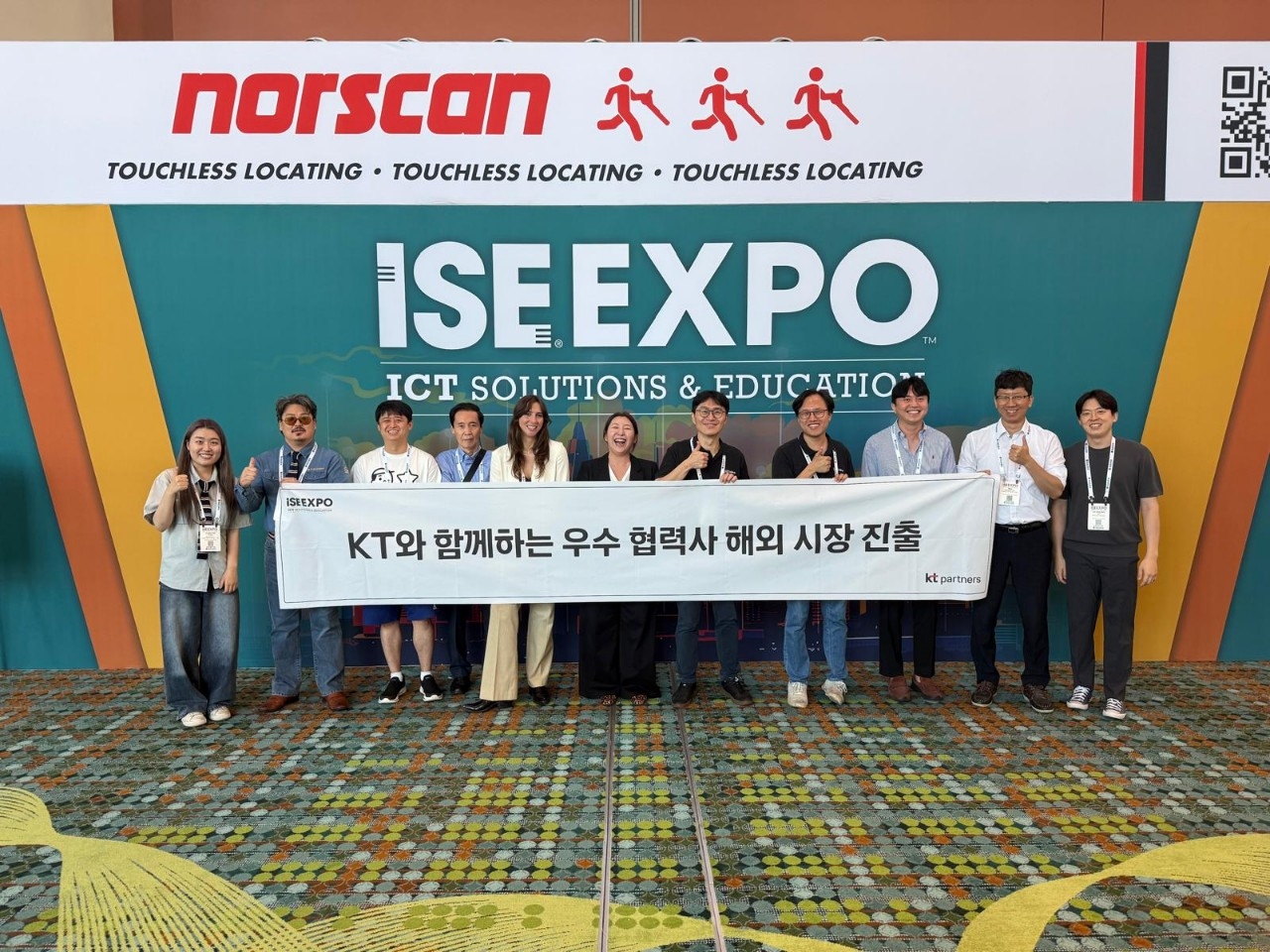 KT Corp employees and partner company staff pose for a photo at the KT Global Win-Win Growth Pavilion inside the ISE EXPO 2026 exhibition hall. [KT Corp]