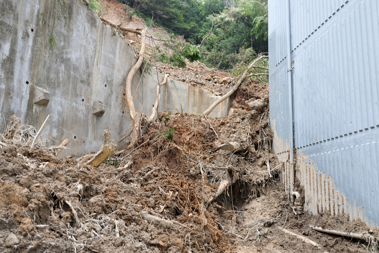 Mud and debris swept down by heavy rain remain behind an apartment complex in Okpo-dong, Geoje, South Gyeongsang Province, Friday. (Yonhap)