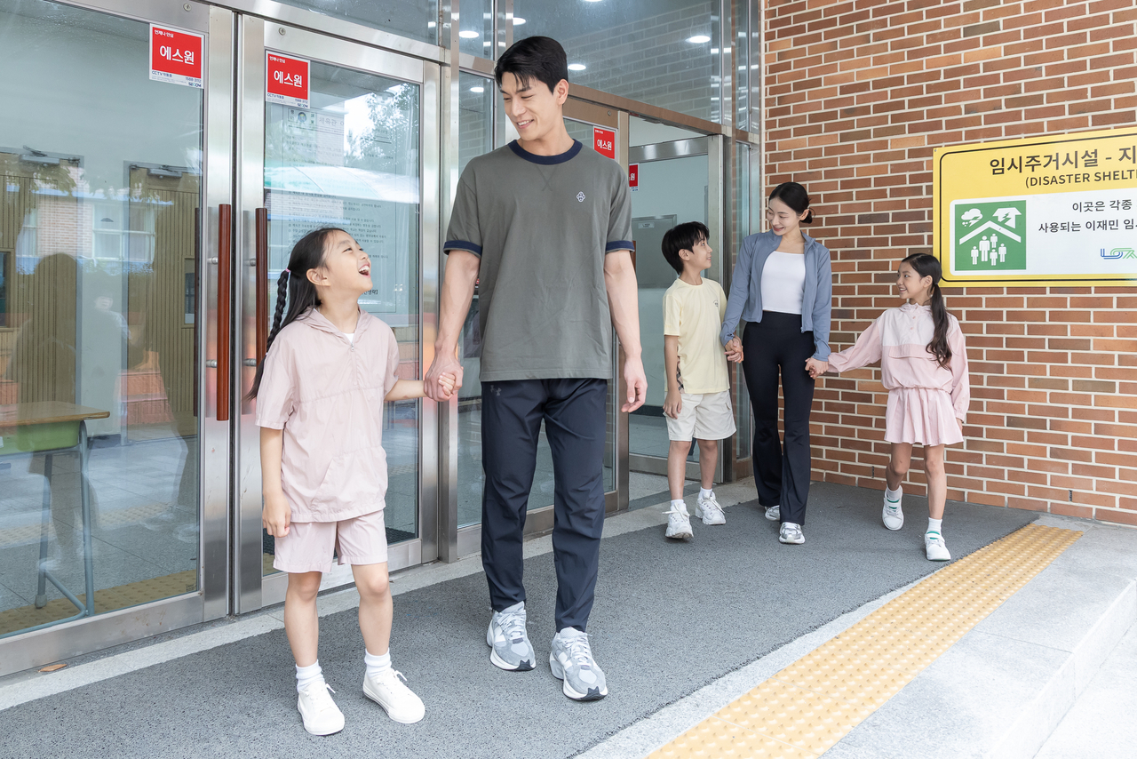 Residents leave a school gymnasium equipped with S-One's school safety solution. [S-One provided]