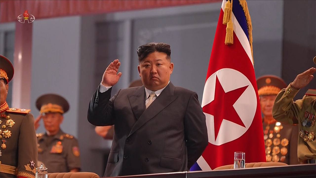 North Korean leader Kim Jong-un watches a commemorative march marking the 73rd anniversary of what North Korea calls its victory in the Korean War at the Pyongyang Indoor Stadium Square on July 27 in this image aired by North Korea’s state-run Korean Central Television the following day. (KCTV-Yonhap)