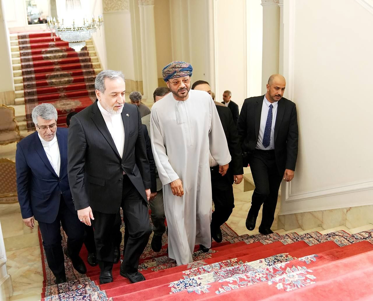 Iranian Foreign Minister Abbas Araghchi (second from left) walking with Omani Foreign Minister Sayyid Badr Al Busaidi (center) during a meeting in Tehran, Iran, Tuesday.   (UPI-Yonhap)