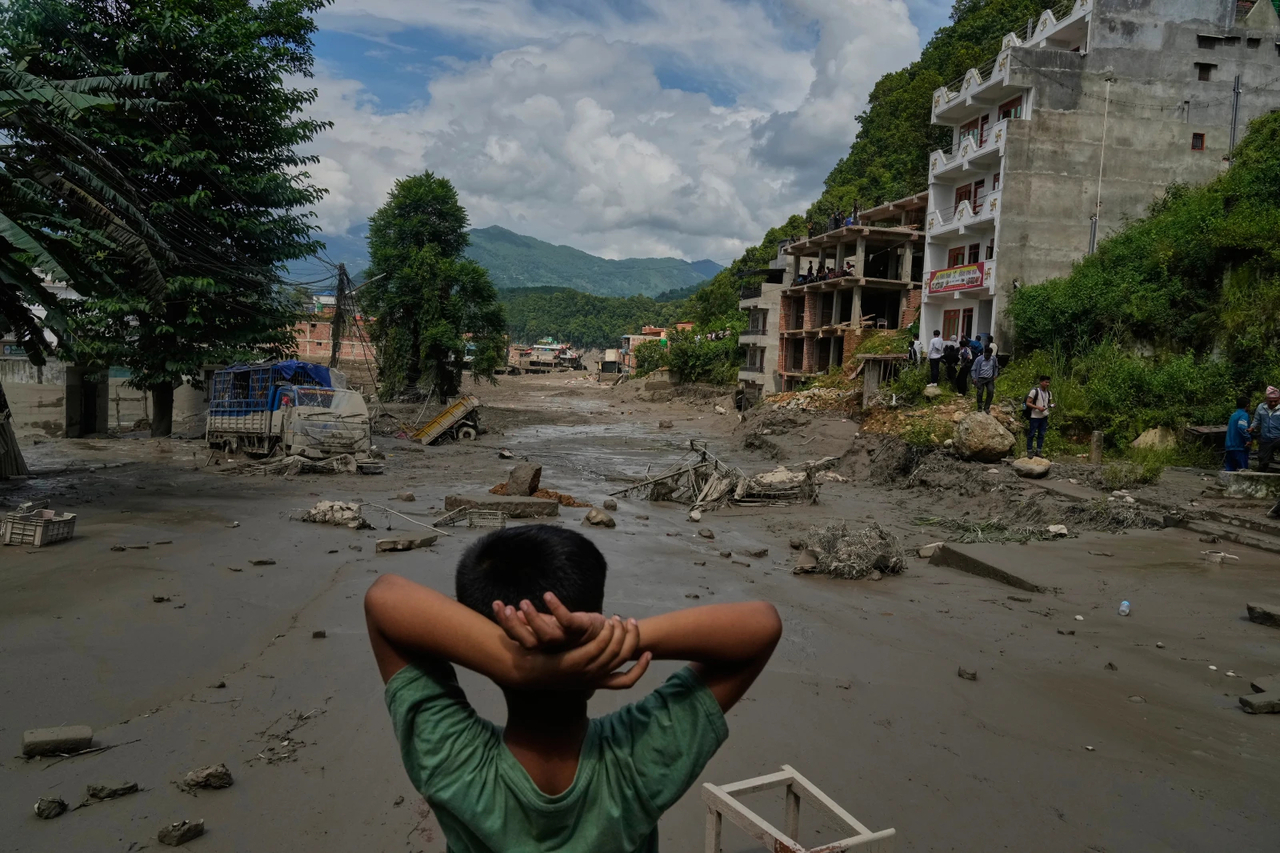 A boy looks at the devastation caused by flash flooding along the Trishuli River in Nepal’s Nuwakot district, Wednesday. (AP)