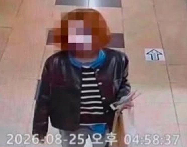 This photo provided to Yonhap News Agency shows a person thought to be a man dressed up as woman, walking around an all-girls high school in Wonju, Gangwon Province, Tuesday. (Yonhap)